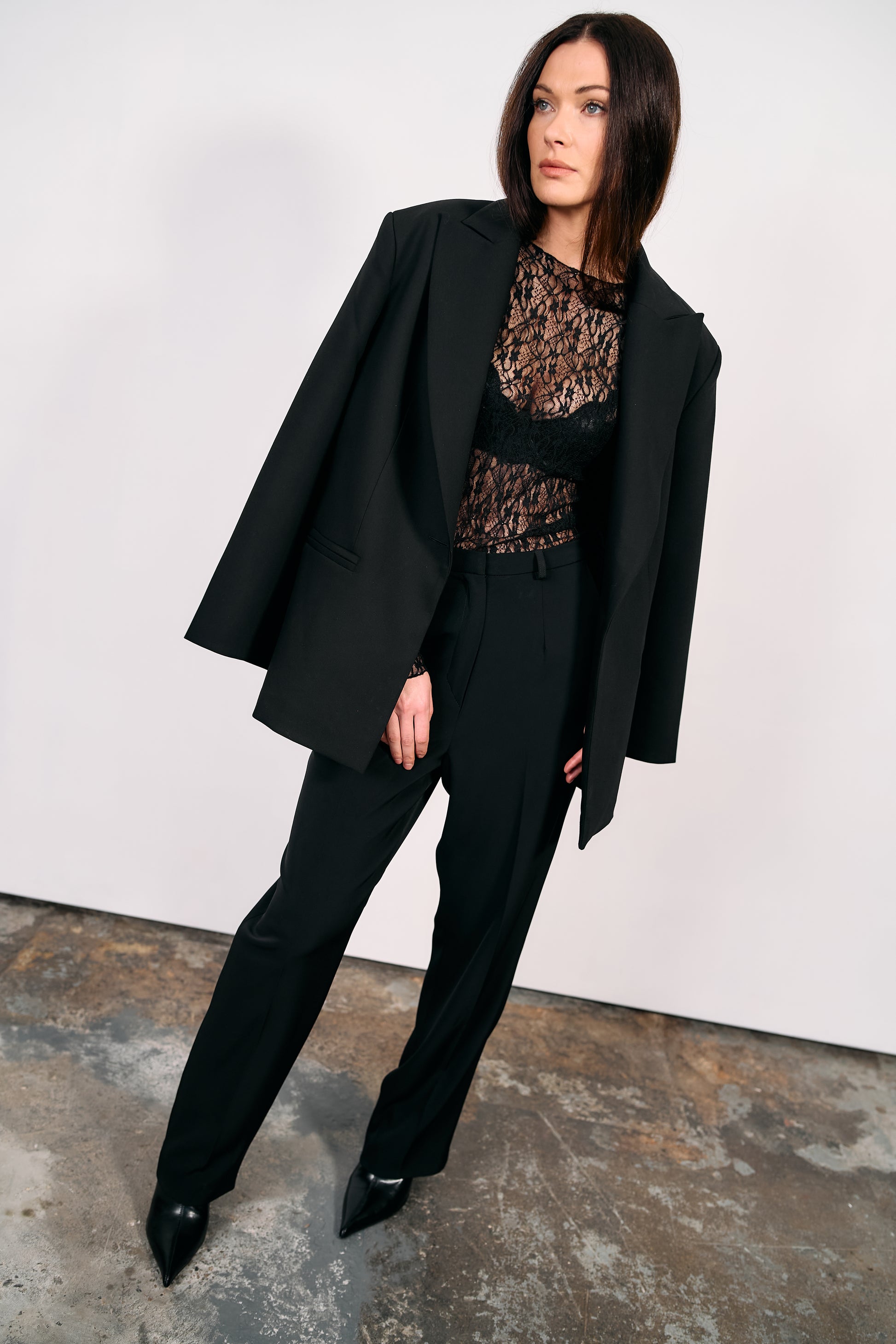 Model wearing BOLDNSUBTLE’s Black Blazer made in Ireland, styled with tailored trousers and lace top against a white background.