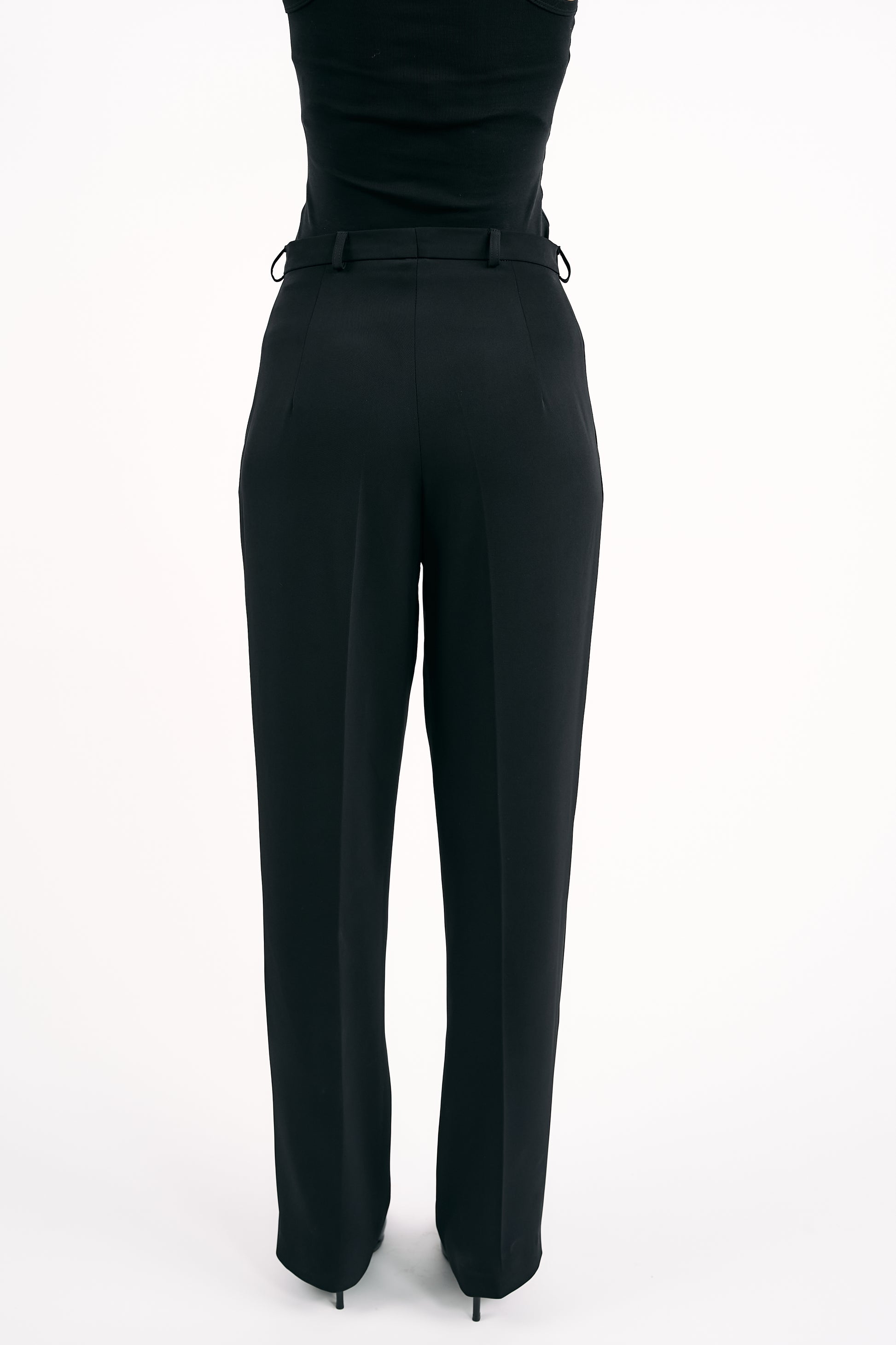Black high-waisted pants on a white background
